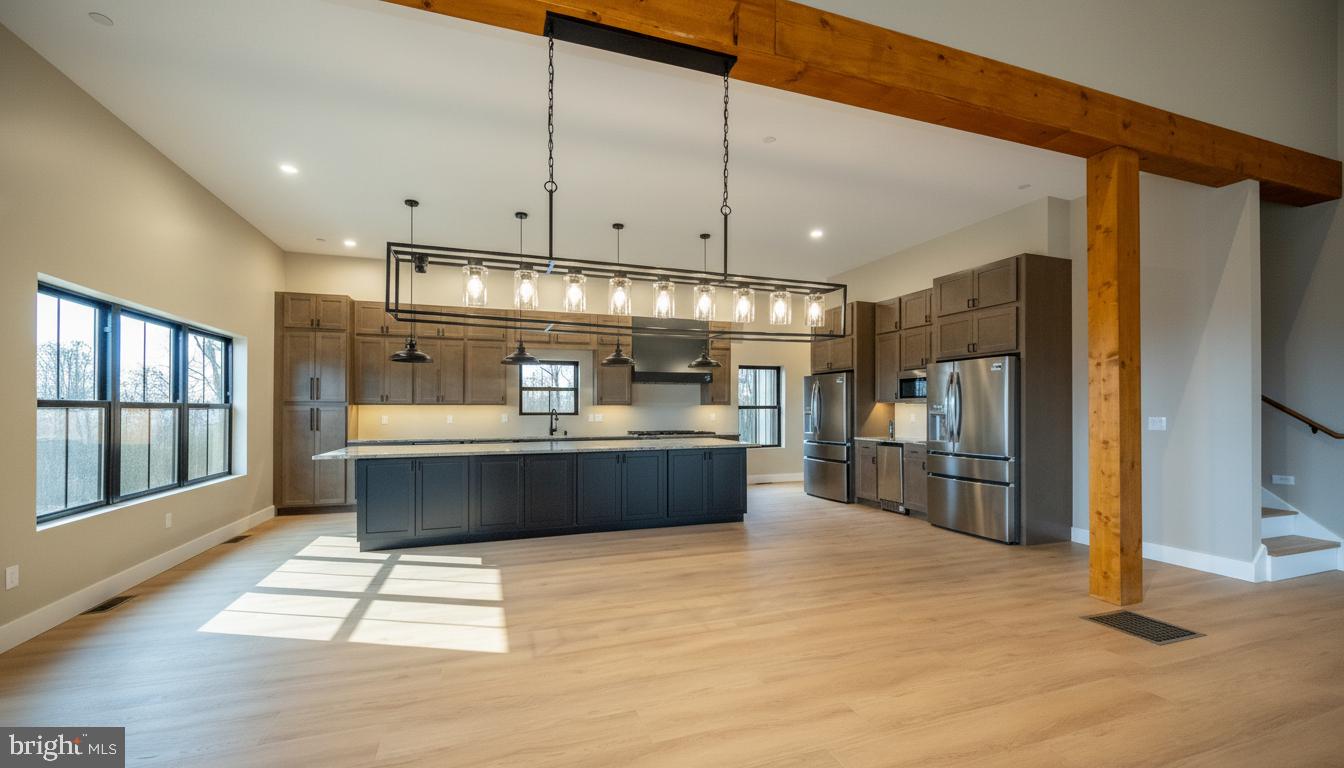 353 Lower Camp Road McHenry, MD 21541 - Photo 9 of 67 a kitchen with stainless steel appliances kitchen island granite countertop a refrigerator a sink and a stove top oven with wooden floor