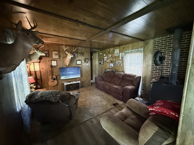 731 Glenn Ferry Road Fair Play, SC 29643 - Photo 6 of 23 A cozy living space features wood paneling, a classic brick fireplace, and ample natural light.