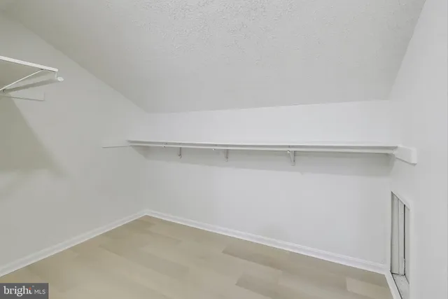 a view of an empty walk in closet