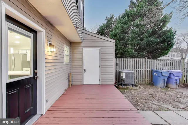an empty room with a cabinet and mirrors