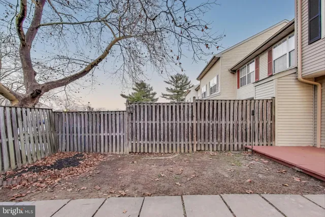 a picture of a bench in front of a white house