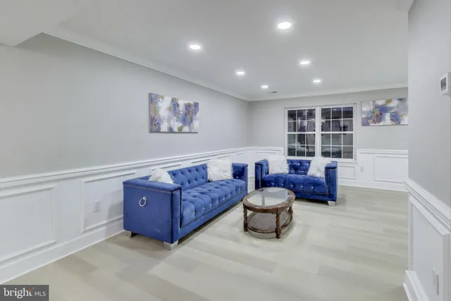 a living room with furniture and a book shelf