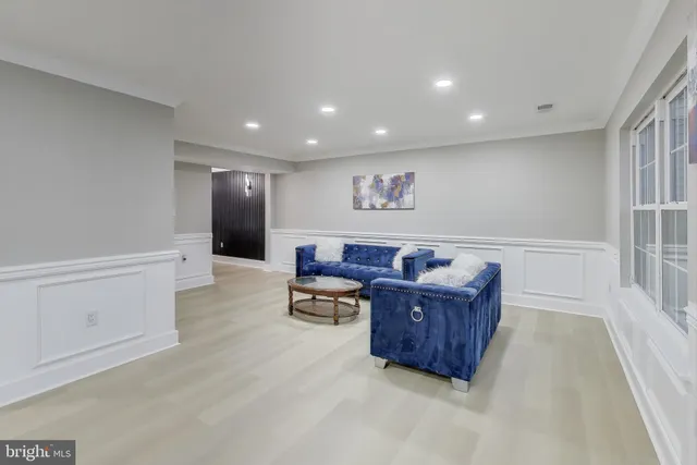 a living room with furniture and a ceiling fan