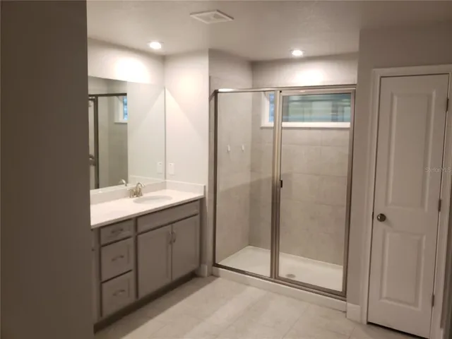 a bathroom with a shower and a sink