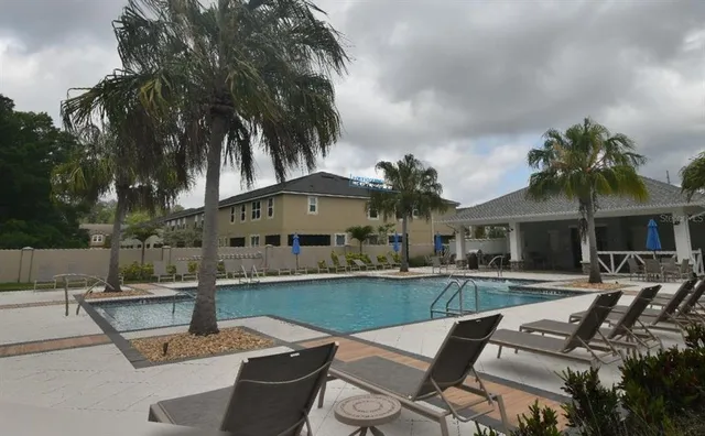 a view of a house with swimming pool and sitting area