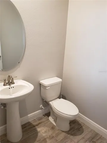 a bathroom with a sink toilet and a mirror