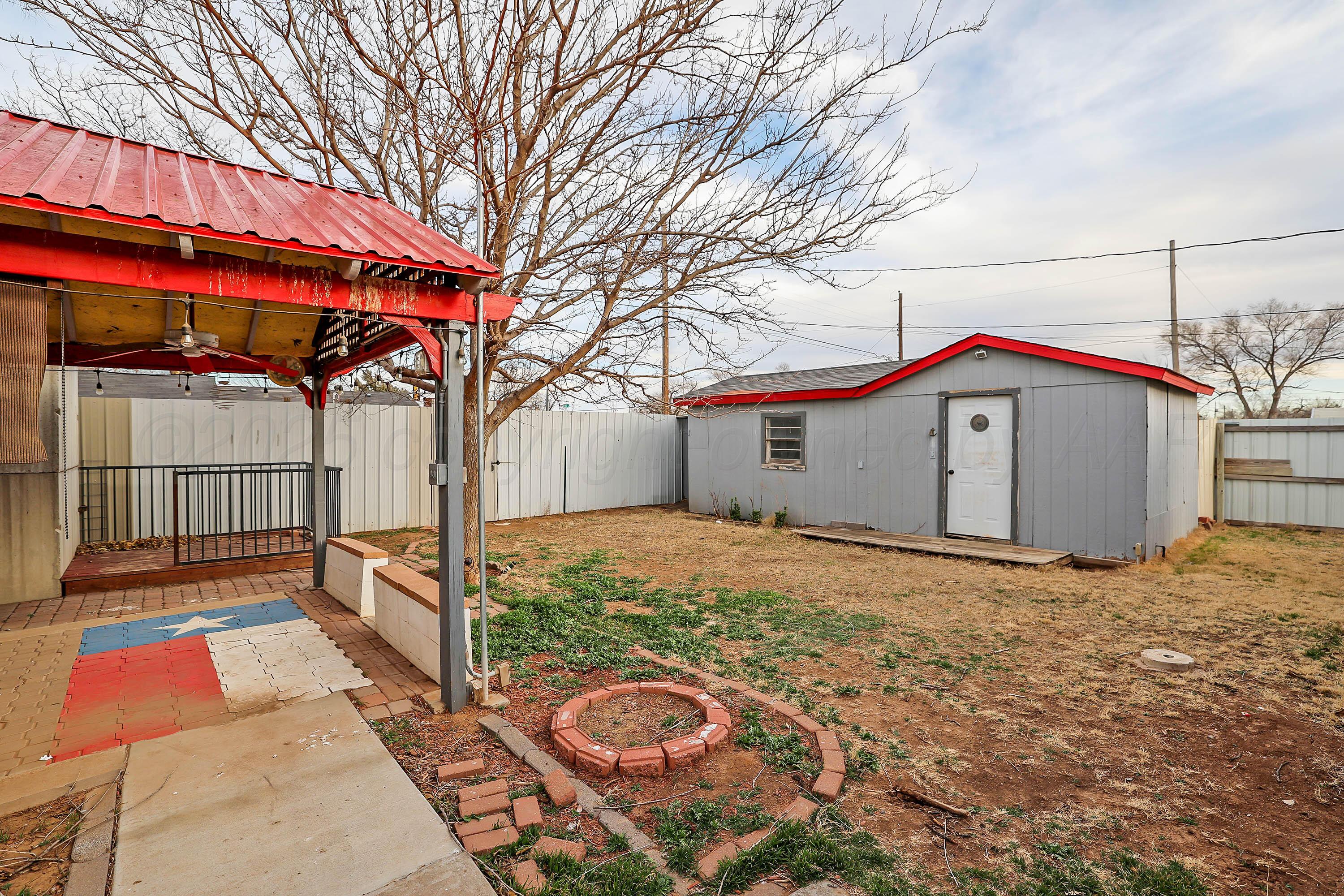 4445 South Travis Street Amarillo, TX 79110 - Photo 25 of 32 a house view with a backyard and wooden fence
