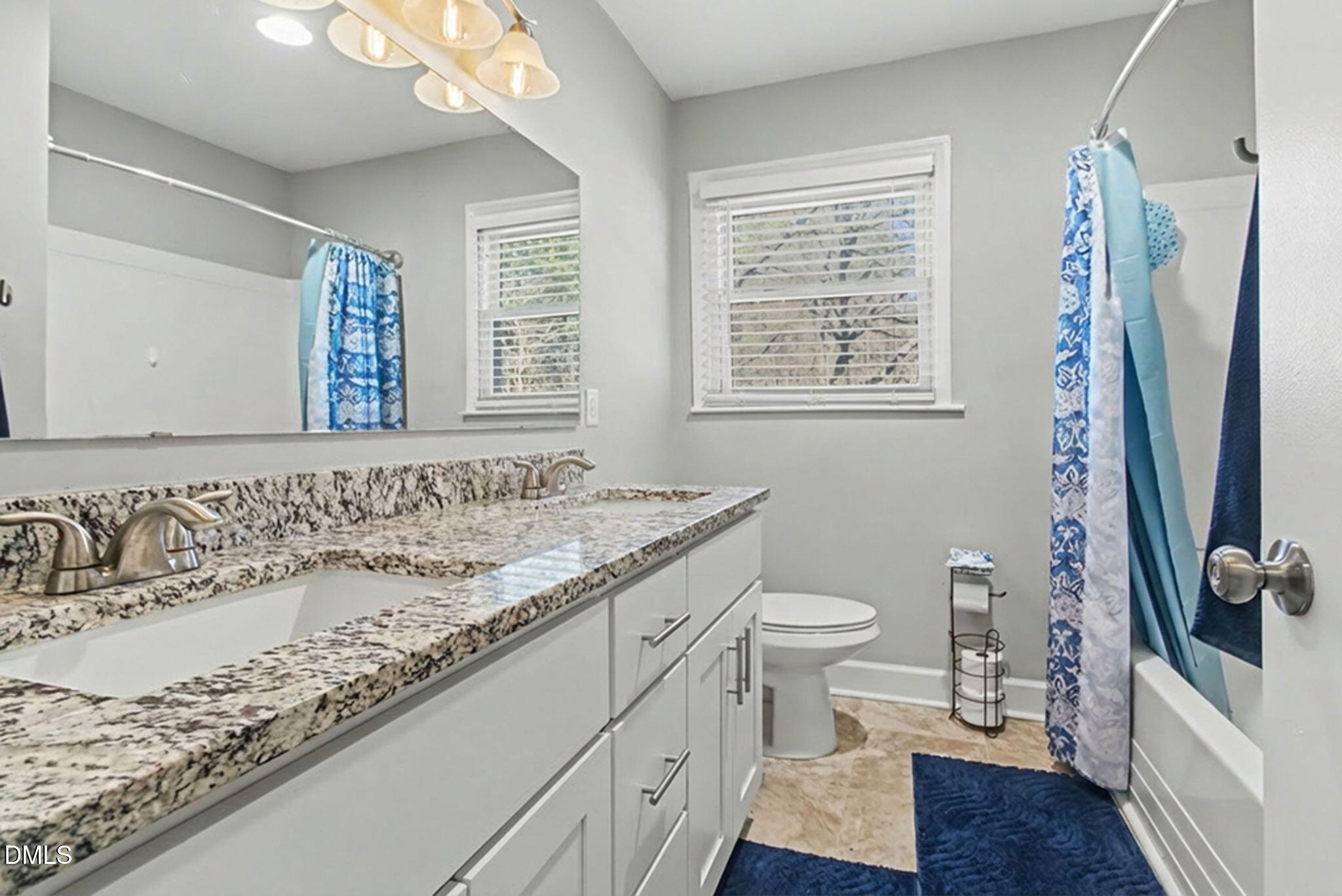 626 South Hoover Road Durham, NC 27703 - Photo 11 of 21 a bathroom with a granite countertop sink toilet and a mirror
