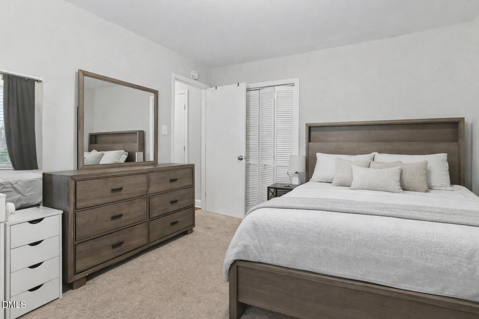 626 South Hoover Road Durham, NC 27703 - Photo 15 of 21 a bedroom with a bed and a dresser