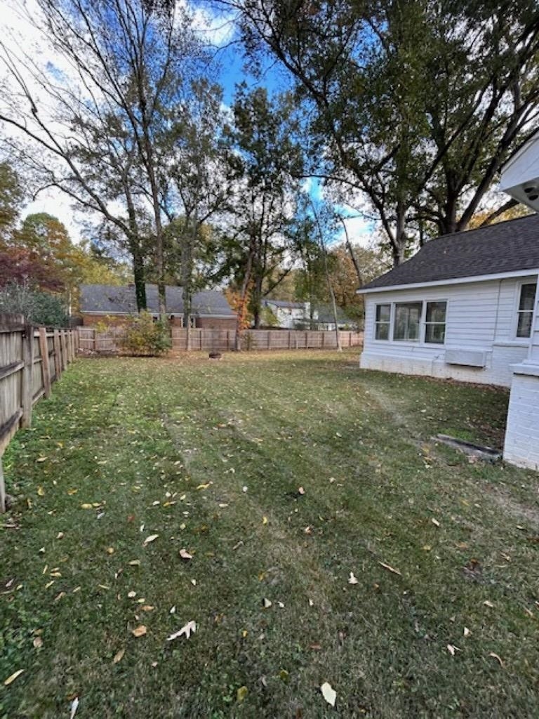 496 Quail Crest Drive Collierville, TN 38017 - Photo 20 of 23 a backyard of a house with large trees and outdoor seating