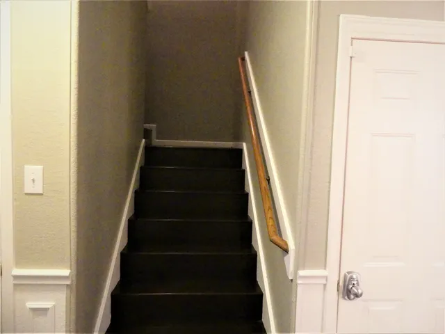 a view of staircase with white walls