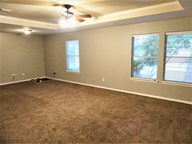an empty room with windows and closet