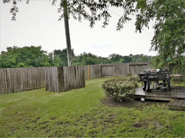 a backyard of a house with table and chairs