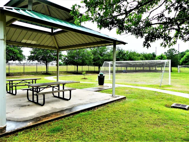 a view of a park with sitting area