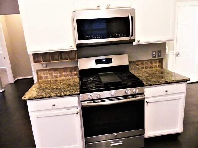 a kitchen with a stove and a microwave
