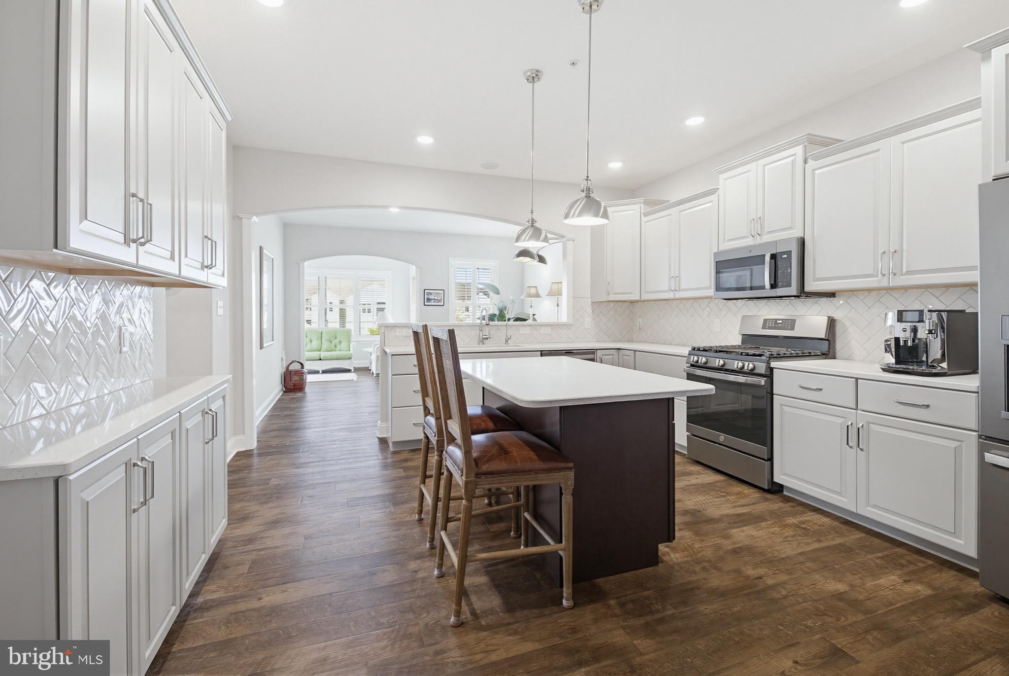 361 Meadow Rose Drive Lititz, PA 17543 - Photo 10 of 39 a kitchen with stainless steel appliances kitchen island granite countertop a table chairs sink and cabinets
