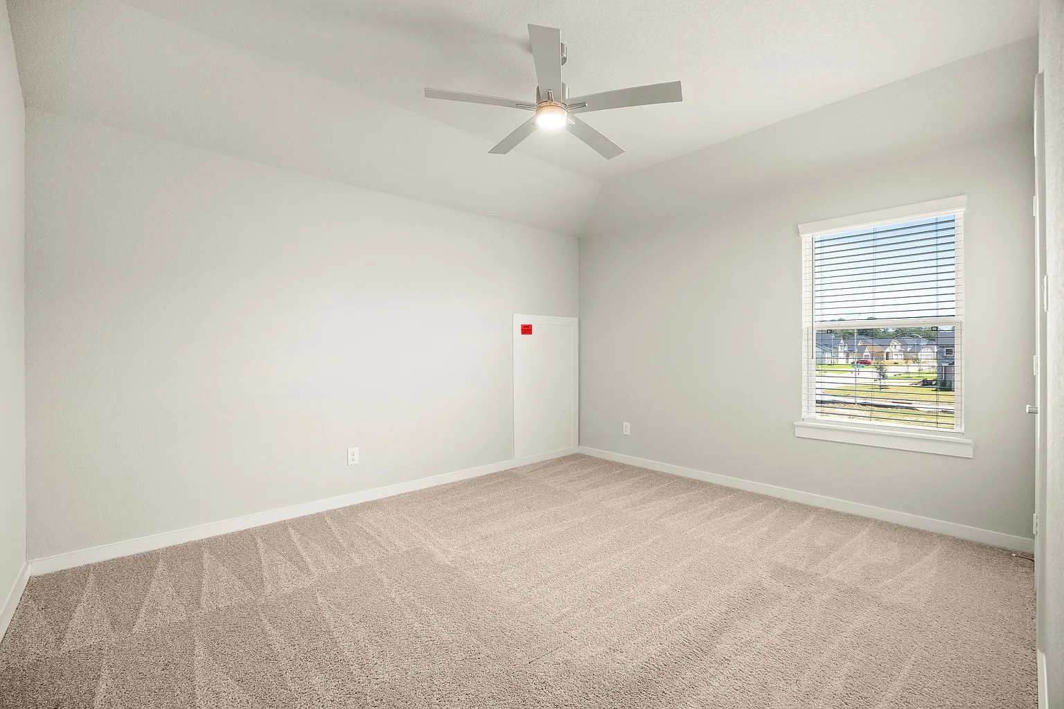 3018 North Spring Drive Spring, TX 77373 - Photo 22 of 25 Bright and airy bedroom featuring soft carpet, a modern ceiling fan, and a large window letting in natural light.