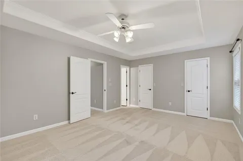 a view of an empty room with a ceiling fan