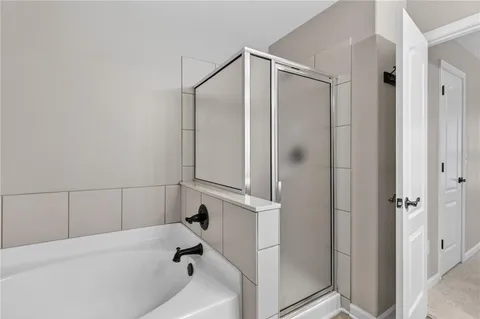 a bathroom with a bathtub and a shower