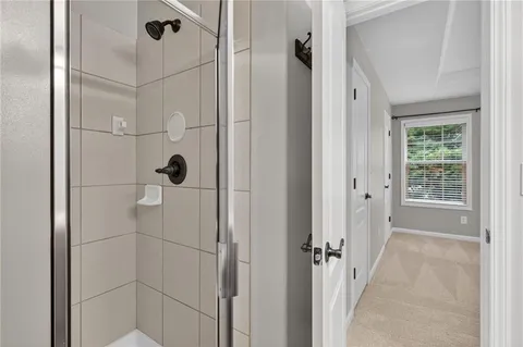 a bathroom with a glass shower door
