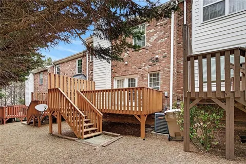 a view of a house with a yard and a patio