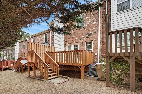 a view of a house with a yard and a patio
