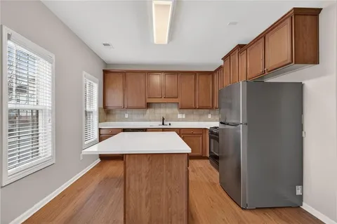 a kitchen with stainless steel appliances granite countertop a refrigerator sink and cabinets