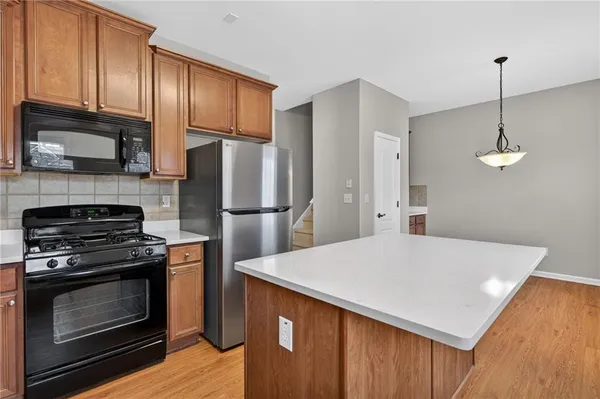 a kitchen with stainless steel appliances a stove a refrigerator and a sink