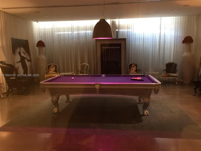 a room with gym equipment and large windows