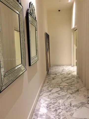 a view of a hallway with seating area