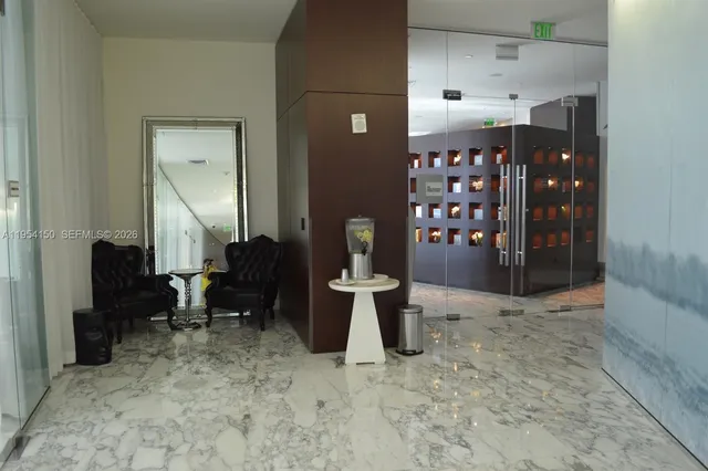 a living room with furniture and large mirror