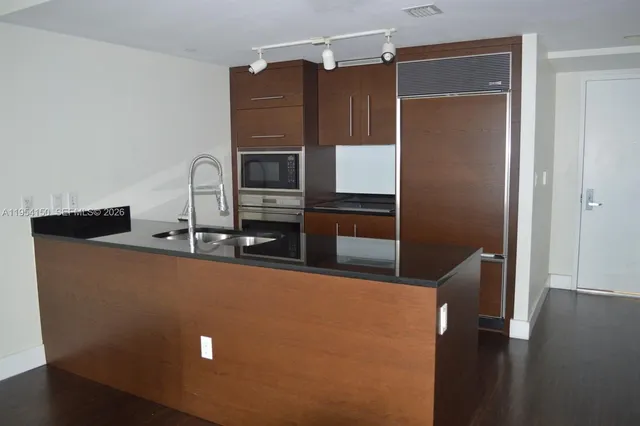 a kitchen with stainless steel appliances a refrigerator and a sink