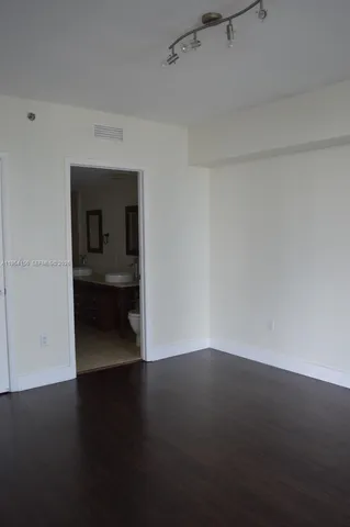 a view of small space with wooden floor and a window