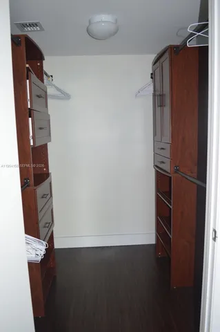 a view of walk in closet with empty racks
