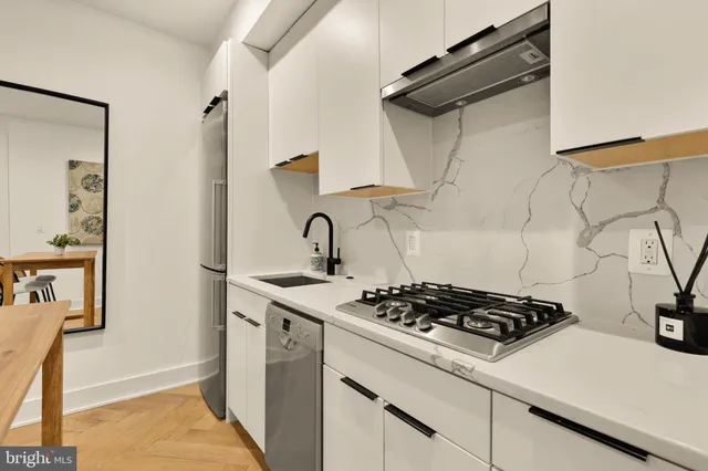a white stove top oven sitting inside of a kitchen