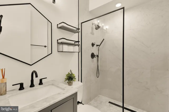 a bathroom with a shower and a sink