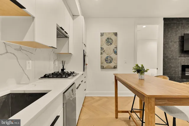 a kitchen with stainless steel appliances granite countertop a sink and a stove