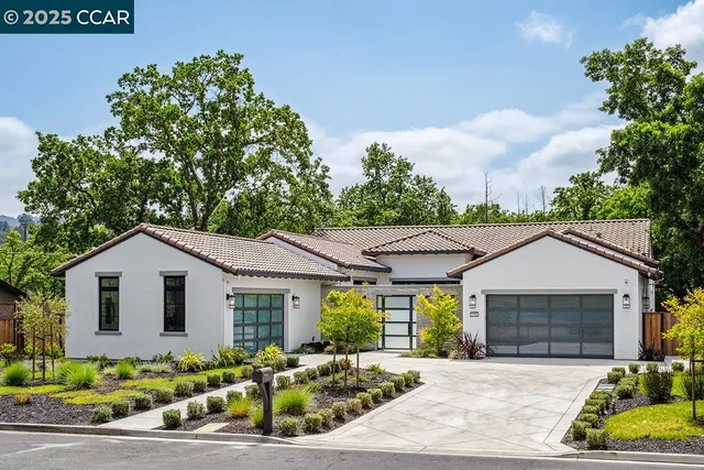 a front view of a house with a garden