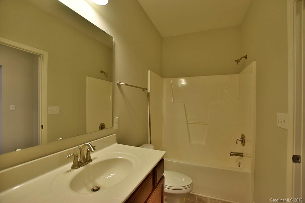 2328 Celandine Way Tega Cay, SC 29708 - Photo 11 of 15 a bathroom with a sink a toilet and shower