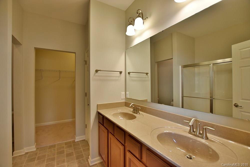 2328 Celandine Way Tega Cay, SC 29708 - Photo 9 of 15 a bathroom with a double vanity sink and a mirror