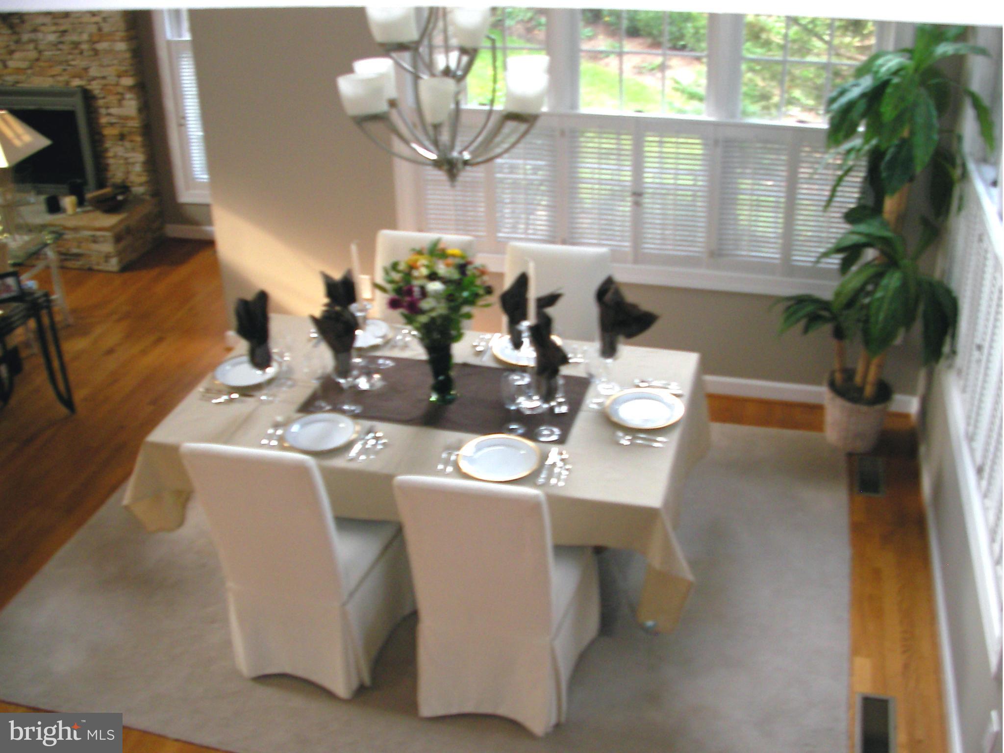 110 South River Landing Road, Unit 110 Edgewater, MD 21037 - Photo 8 of 30 a dining room with furniture potted plants and wooden floor