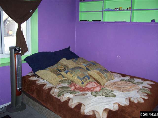 2688 Zinnia Avenue Reno, NV 89512 - Photo 5 of 6 a bed with a bed and a painting