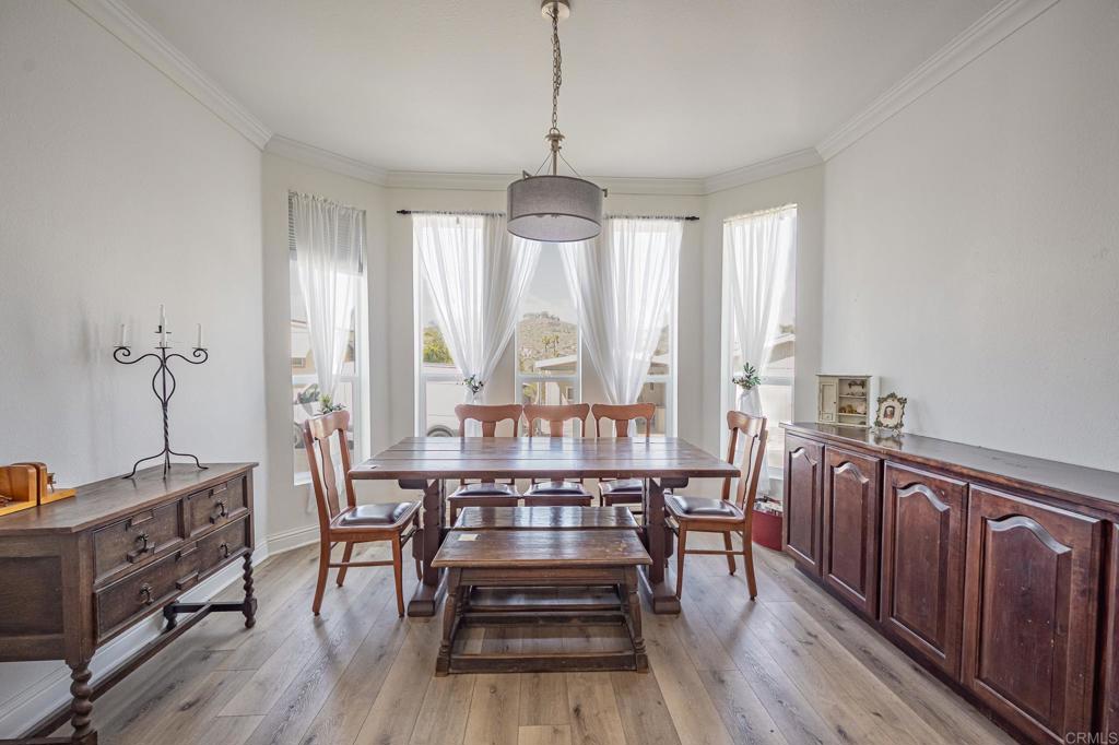4650 Dulin Road, Unit 137 Fallbrook, CA 92003 - Photo 13 of 54 a view of a dining room with furniture window and wooden floor