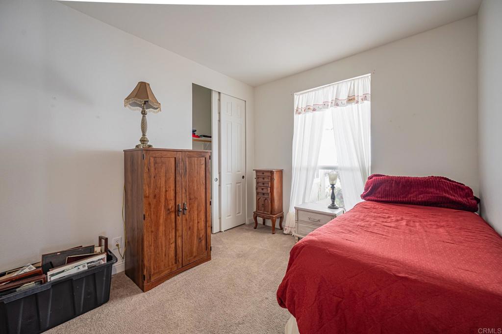 4650 Dulin Road, Unit 137 Fallbrook, CA 92003 - Photo 17 of 54 a bedroom with a bed and a window