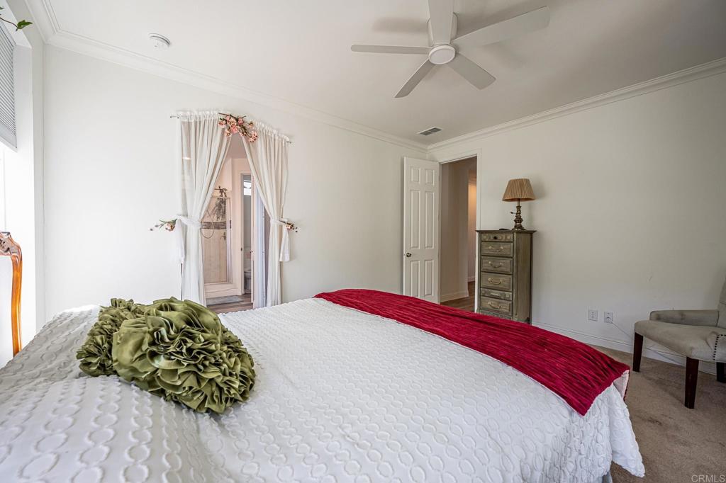 4650 Dulin Road, Unit 137 Fallbrook, CA 92003 - Photo 19 of 54 a bedroom with a bed and a chandelier