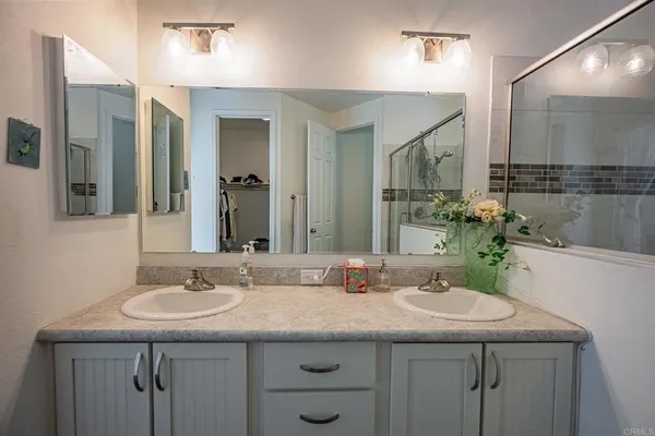 a bathroom with a shower and vanity