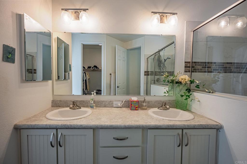 4650 Dulin Road, Unit 137 Fallbrook, CA 92003 - Photo 20 of 54 a bathroom with a granite countertop sink and a mirror
