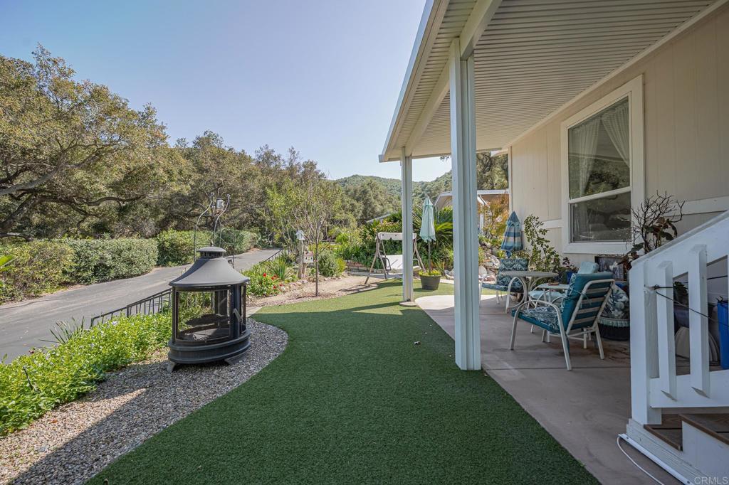4650 Dulin Road, Unit 137 Fallbrook, CA 92003 - Photo 28 of 54 a view of a chair and tables under the backyard