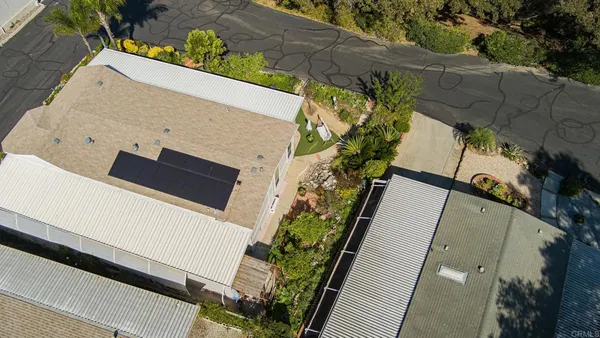 an aerial view of a residential houses with yard