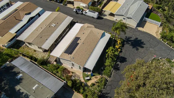 an aerial view of residential houses with outdoor space